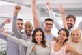 Three cheers for business success. Cropped shot of a group of businesspeople smiling and raising their hands. Royalty Free Stock Photo