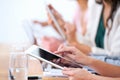 Wireless freedom in the boardroom. Cropped shot of a group of businesspeople using their wireless devices during a Royalty Free Stock Photo