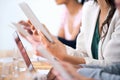 Wireless freedom in the boardroom. Cropped shot of a group of businesspeople using their wireless devices during a Royalty Free Stock Photo