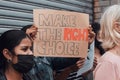 Make the right choice. Cropped shot of a group of demonstrators holding up signs protesting against the covid 19 vaccine