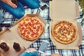 Feasting with friends. Cropped shot of a group of friends eating pizza while having a picnic. Royalty Free Stock Photo