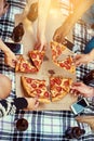 Good food, great friends, glorious times. Cropped shot of a group of friends eating pizza while having a picnic. Royalty Free Stock Photo