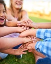 Its cool to be kind. Cropped shot of a group of kids stacking their hands on top of each other.