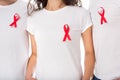 People in blank t-shirts with aids ribbons