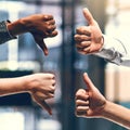 Getting mixed reviews. Cropped shot of a group of unrecognizable businesspeople gesturing thumbs up and down.