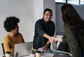 Its been a pleasure doing business with you. Cropped shot of a group of young businesspeople greeting each other with a Royalty Free Stock Photo