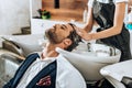 Cropped shot of hairstylist washing hair to handsome male client Royalty Free Stock Photo