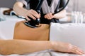 Cropped shot of hands of cosmetologist doing ultrasound cavitation procedure on the belly of woman. Unrecognizable woman Royalty Free Stock Photo