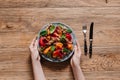 cropped shot of hands holding plate with gourmet salad with mussels Royalty Free Stock Photo