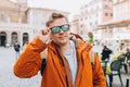 Cropped shot of a handsome man traveling through the city. Young men in sunglasses with a yellow backpack walking along Royalty Free Stock Photo