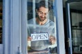 Proud shop owner. Cropped shot of a handsome young cafe owner. Royalty Free Stock Photo