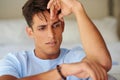 What did I do wrong. Cropped shot of a handsome young looking contemplative while sitting at home.