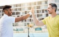 You dominated that game. Cropped shot of a handsome young male tennis player high fiving his coach while standing Royalty Free Stock Photo