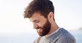 The beard is what makes the man. Cropped shot of a handsome young man spending the day at the beach. Royalty Free Stock Photo