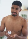 Lets tidy up this beard a bit. Cropped shot of a handsome young man standing and using his bathroom mirror to shave in Royalty Free Stock Photo