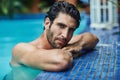 Cooling down in the best way. Cropped shot of a handsome young man in the swimming pool at home. Royalty Free Stock Photo