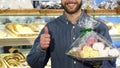 Cropped shot of a happy bearded man showing thumbs up at the bakery Royalty Free Stock Photo