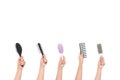 cropped shot of human hands holding various hairbrushes