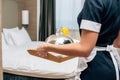 cropped shot of maid in uniform holding breakfast covered with cloche Royalty Free Stock Photo