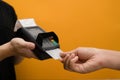 Cropped shot of male barista receiving payment via credit card from customer. Electronic money, contactless payment Royalty Free Stock Photo