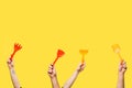 cropped shot of male and female hands holding red and yellow plastic shovels and rakes isolated Royalty Free Stock Photo