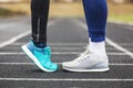 Cropped shot of a male and female legs in running shoes close to Royalty Free Stock Photo