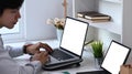 Cropped shot of male freelance working with multiple device at his workplace. Royalty Free Stock Photo