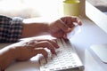 Cropped shot of male hands holding credit card for online shopping over the desk. Royalty Free Stock Photo