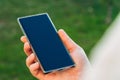 Close-up shot of male hands holding smartphone with blank screen copy space for your text message or information content, against