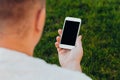 Close-up shot of male hands holding smartphone with blank screen copy space for your text message or information content, against