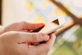 Close-up shot of male hands holding smartphone with blank screen copy space for your text message or information content, against