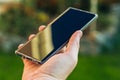 Close-up shot of male hands holding smartphone with blank screen copy space for your text message or information content, against