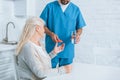 cropped shot of male nurse giving glass of water and pills to senior Royalty Free Stock Photo