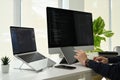 Cropped shot of male programmer working on laptop to check coding in bugging system in IT office