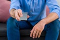 cropped shot of man changing channels while watching tv Royalty Free Stock Photo