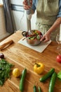 Cropped shot of man, chef cook using hand blender while preparing Italian meal in the kitchen Royalty Free Stock Photo