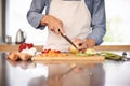 Hes one of a kind. Cropped shot of a man chopping up some vegtables.