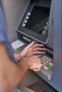 Keeping his pin code a secret. Cropped shot of a man entering his secret pin code at an ATM. Royalty Free Stock Photo