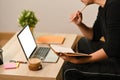 Man holding bookend using laptop computer in living room. Royalty Free Stock Photo