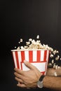 cropped shot of man holding cardboard bucket of popcorn Royalty Free Stock Photo