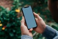 Cropped shot of man holding smartphone with mockup