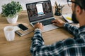 cropped shot of man in plaid shirt using laptop with linkedin website Royalty Free Stock Photo