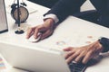 Cropped shot of a man's hands using a laptop at home, rear view Royalty Free Stock Photo