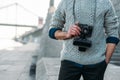 cropped shot of man in stylish sweater with vintage film camera outdoors Royalty Free Stock Photo
