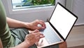 Cropped shot of man using laptop in living room. Royalty Free Stock Photo