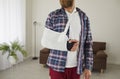 Man who has broken arm, hand, wrist or elbow is wearing bandage and support sling Royalty Free Stock Photo