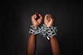 I want to break free. Cropped shot of a mans hands tied up with chains against a black background. Royalty Free Stock Photo