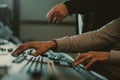 cropped shot of men using analog graphic equalizer