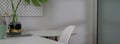 Cropped shot of minimal home office interior design with white worktable