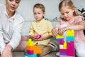 cropped shot of mother with cute little kids playing with colorful blocks Royalty Free Stock Photo